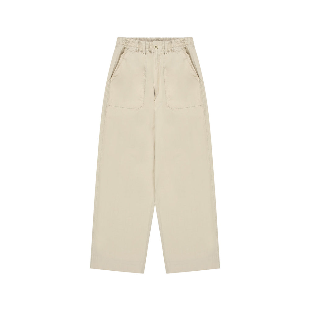 The Kappy One Tuck Wide Fatigue Pant is a beige, straight-leg unisex style in one size, featuring an elastic waistband, button closure, and two front patch pockets. Displayed flat on a white background.