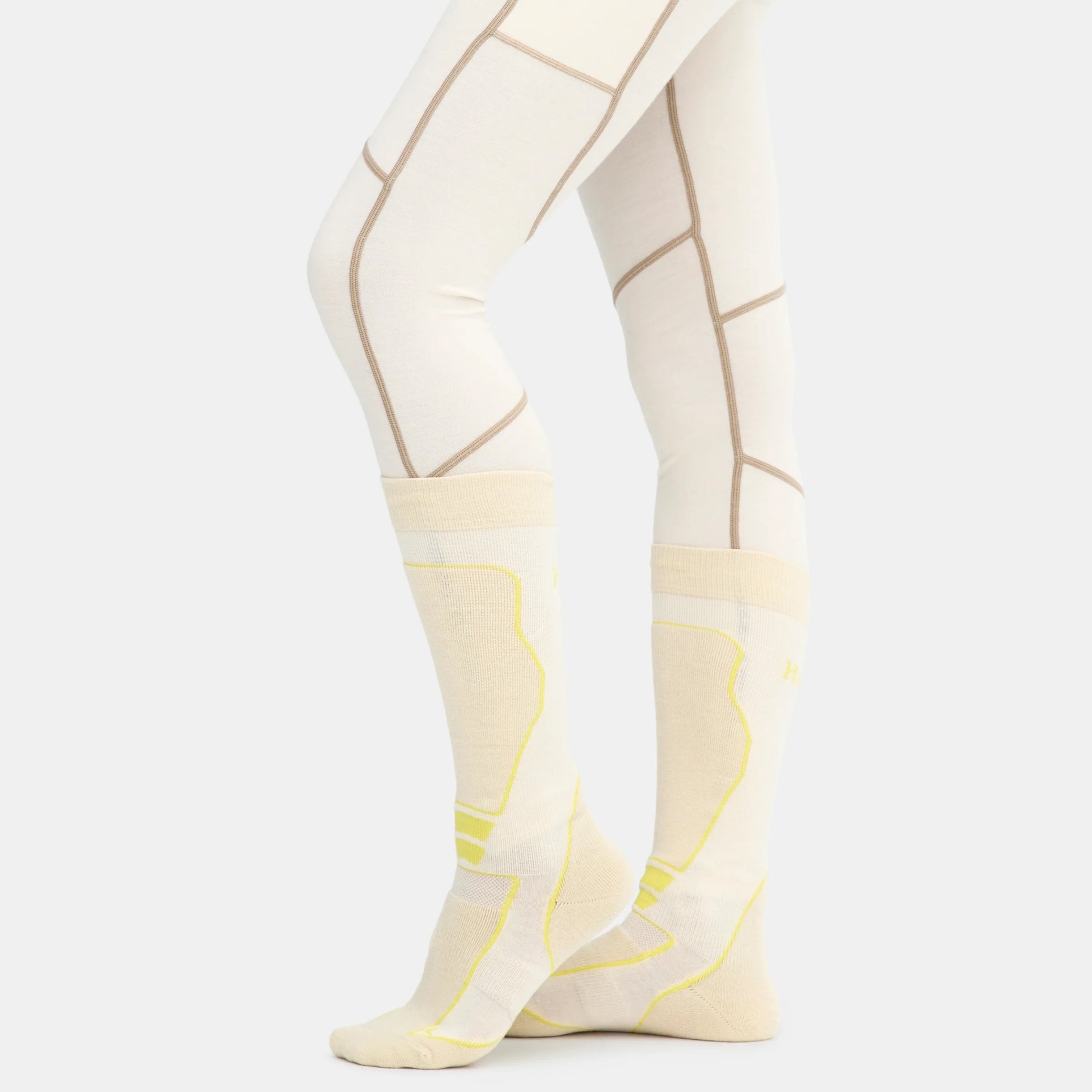 Side view of ski socks in oat on model