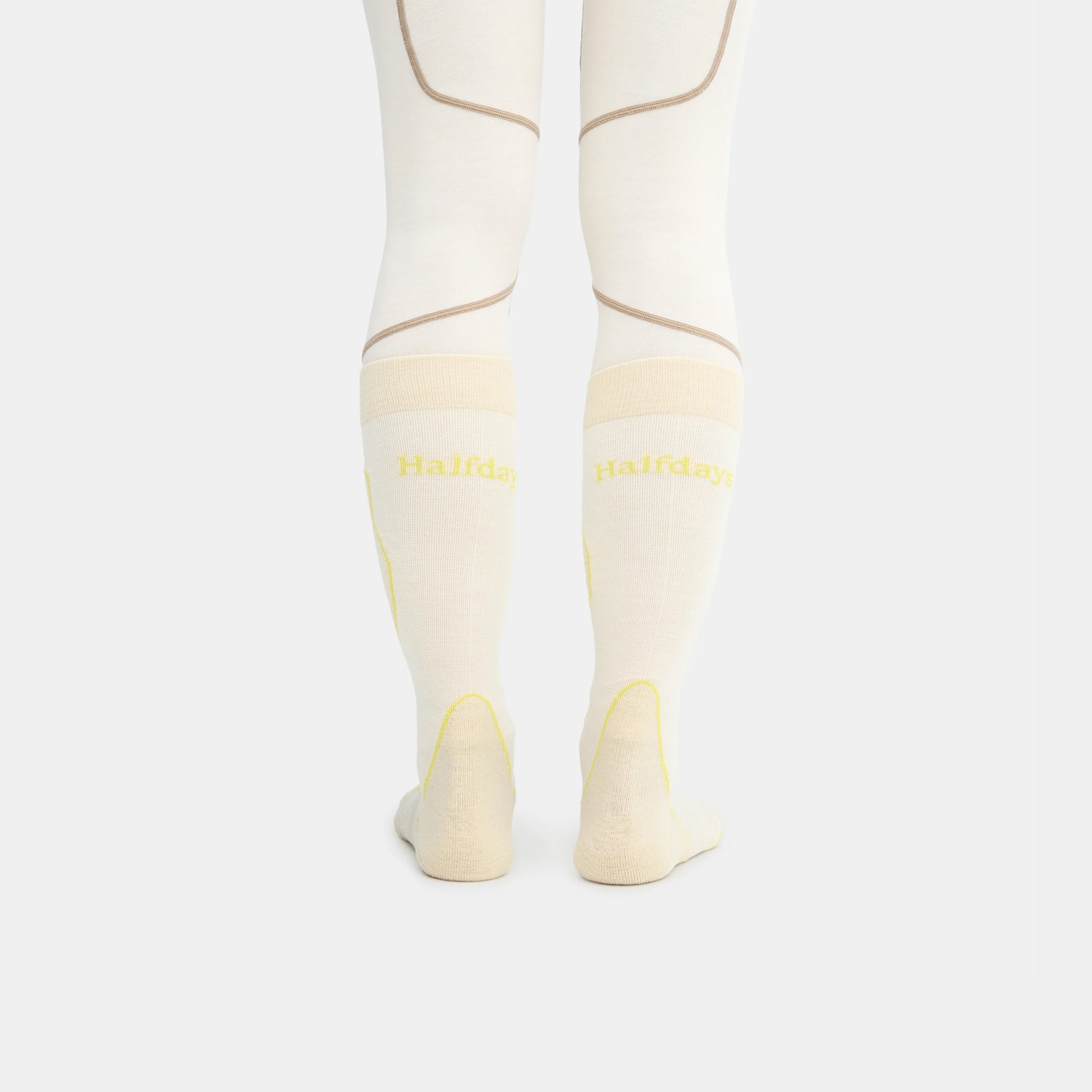 Woman wearing socks with "HALFDAYS" logo on back