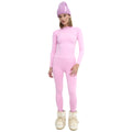 A person wearing Halfdays' Sophia Legging paired with a pink long-sleeve top, purple beanie, and white boots, standing against a white background.