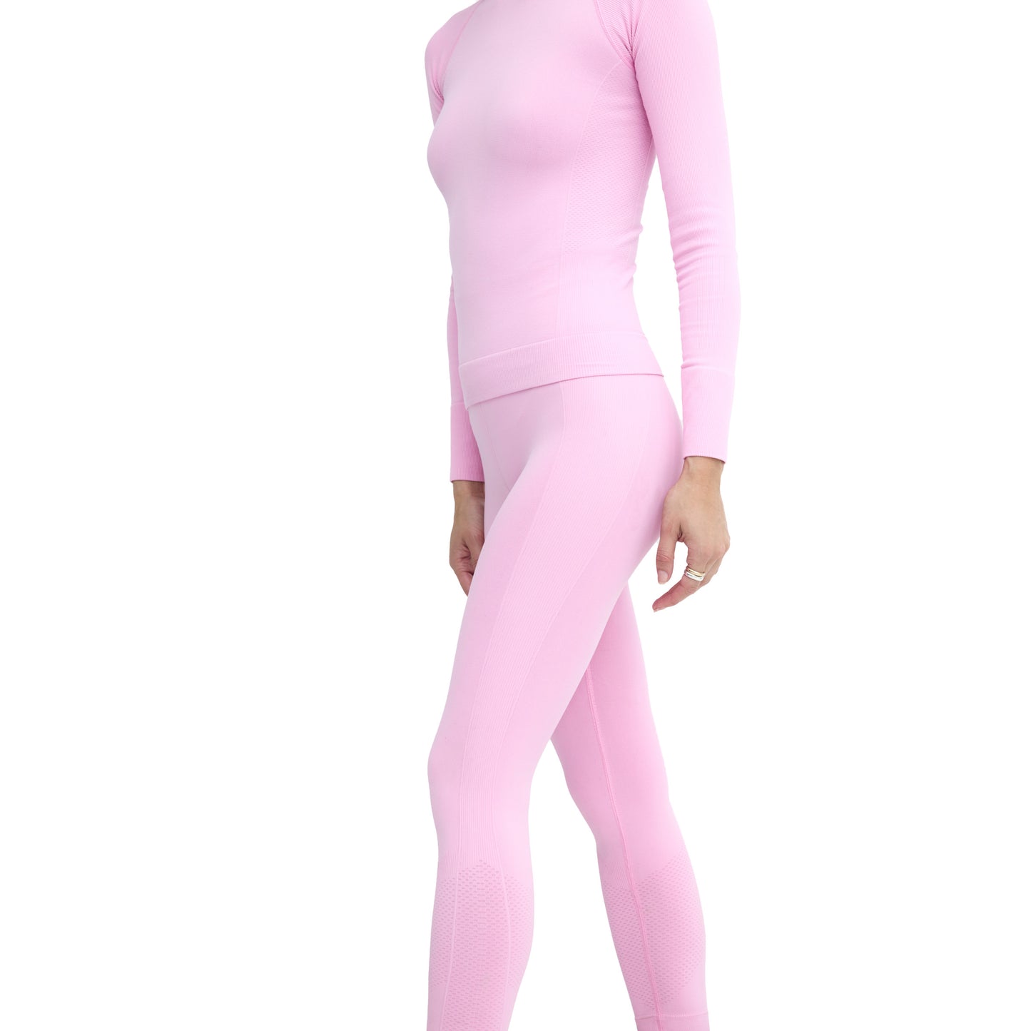 An individual wearing the Sophia Legging by Halfdays in a full-body pink athletic outfit, made of seamless nylon fabric, stands against a white background.
