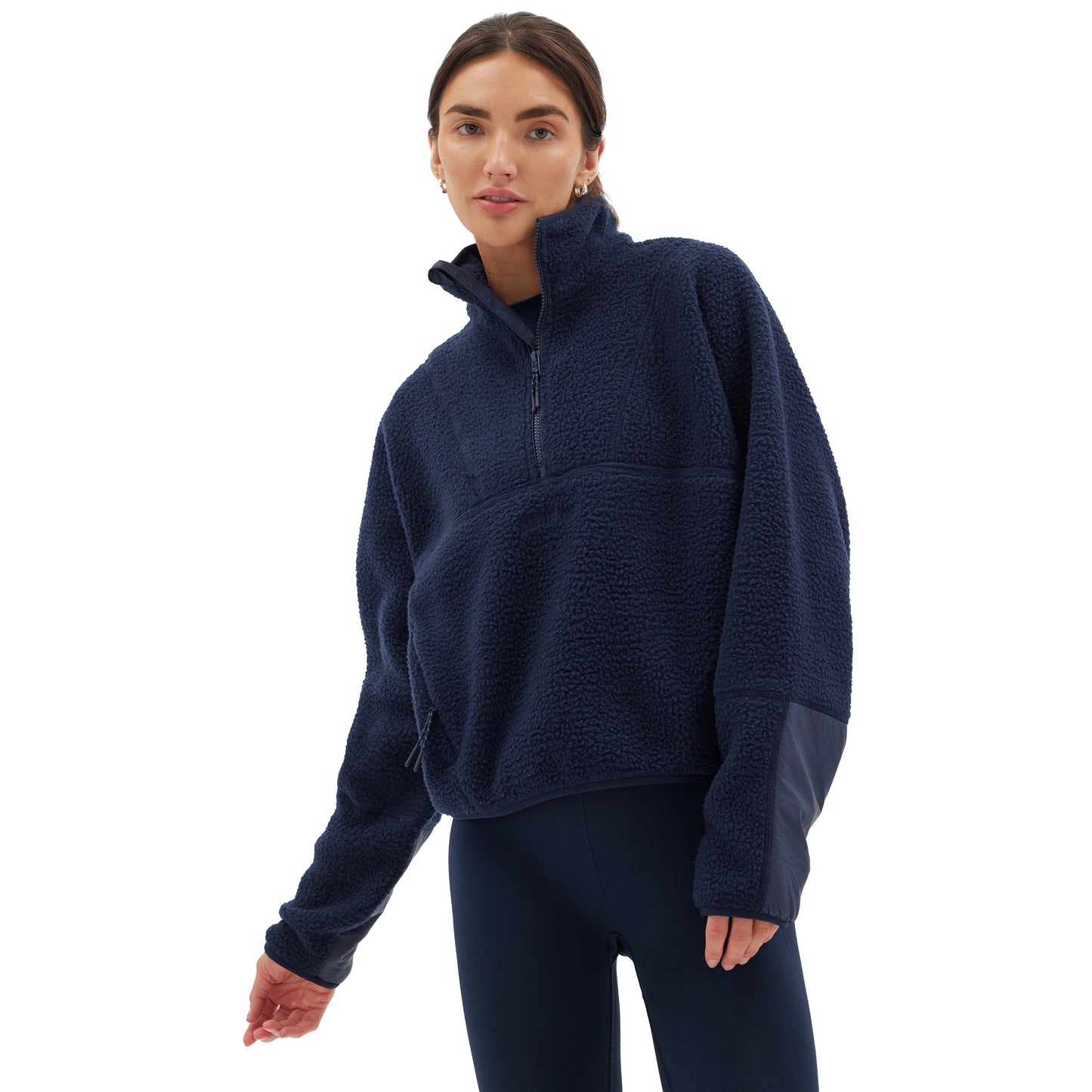 A person wearing the Halfdays Pieper Fleece in navy blue and leggings stands against a white background.