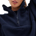 A person is wearing a Pieper Fleece jacket by Halfdays, featuring a dark blue color and a partially opened quarter-zip design.