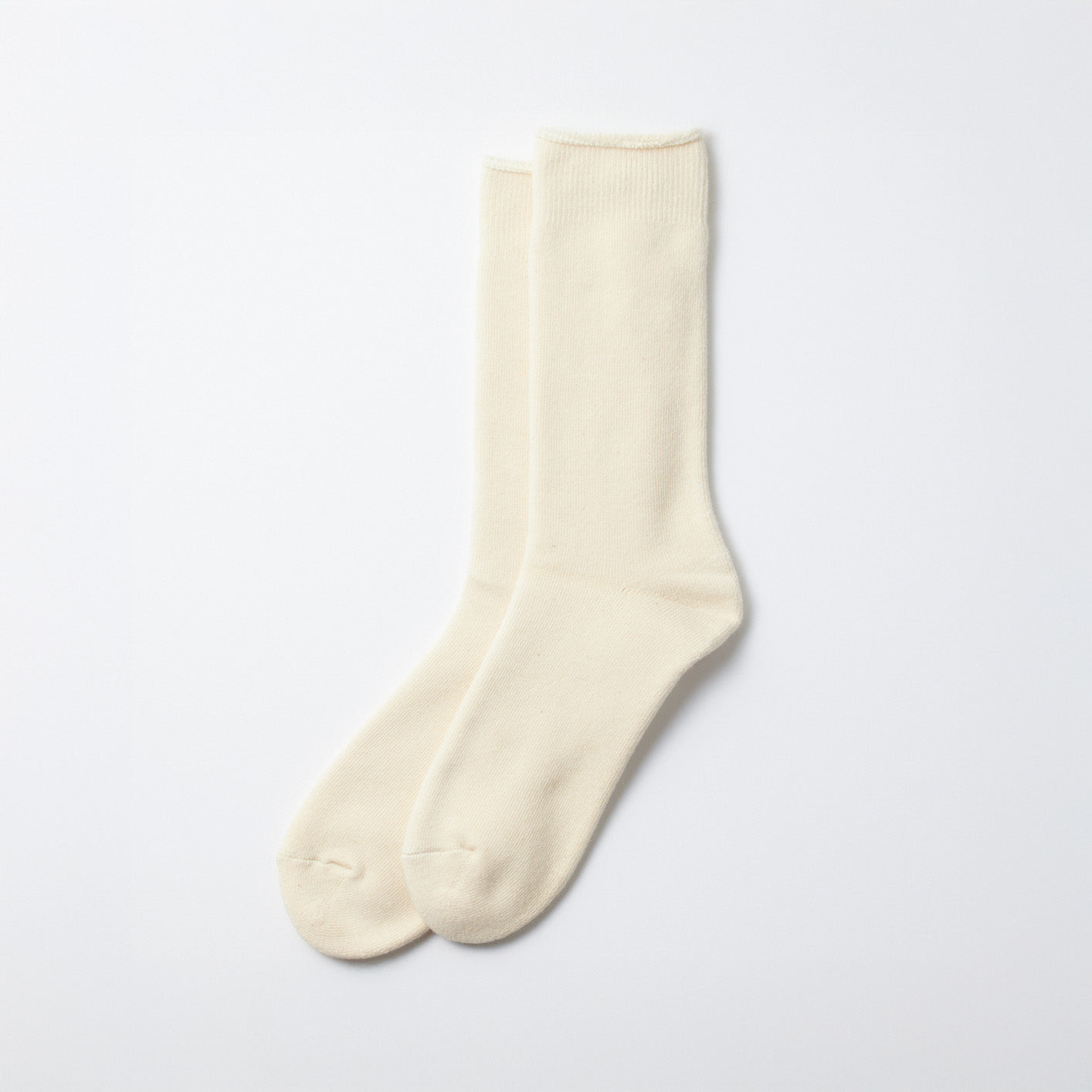 A set of three Organic Daily Ribbed Crew Socks in ecru from RoToTo, showcased on a simple white background.