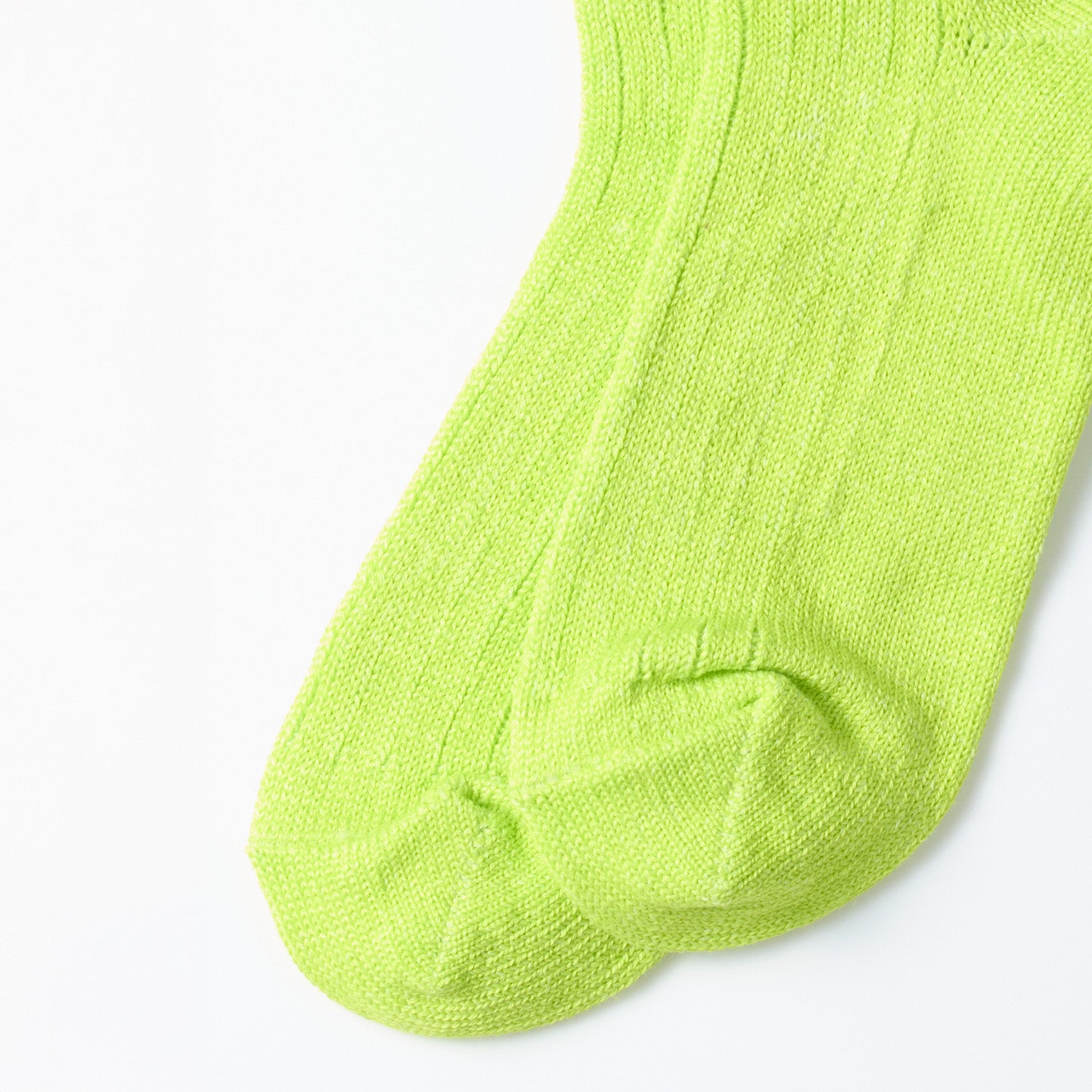 Laid flat on a white surface are RoToTo's Everyday Pile Ankle Socks in lime, featuring a ribbed texture.