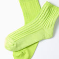 A pair of RoToTo's lime Everyday Pile Ankle Socks on a white background.