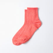 A single pink Everyday Pile Ankle Sock by RoToTo, featuring a ribbed pattern, lies flat on a white surface.