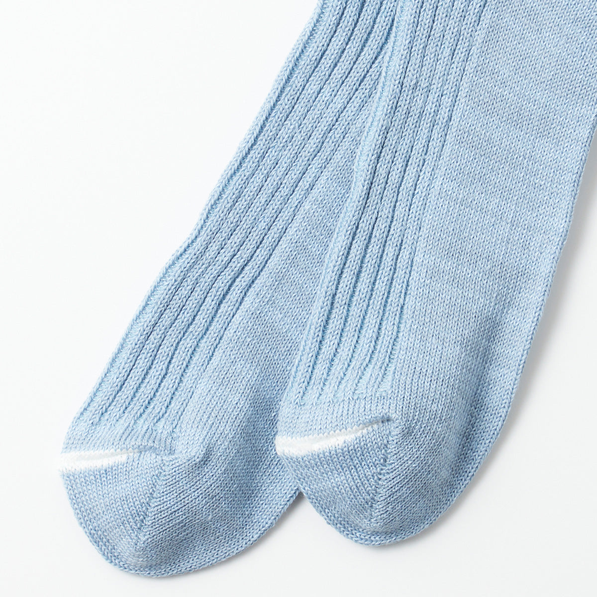 Close-up of RoToTo's Hemp/Organic Cotton Stripe Sock in Morning Blue/White, featuring ribbed details and white accents at the toes, set against a plain background.