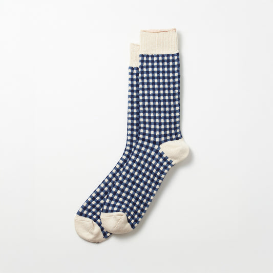 The RoToTo Gingham Check Socks in Navy feature a blue and white checkered pattern with beige accents on the toes, heels, and cuffs, laid flat on a light background.