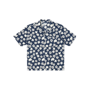 A Road Shirt by Universal Works, featuring an Indigo Flower design with short sleeves and a collar, displayed against a black background.