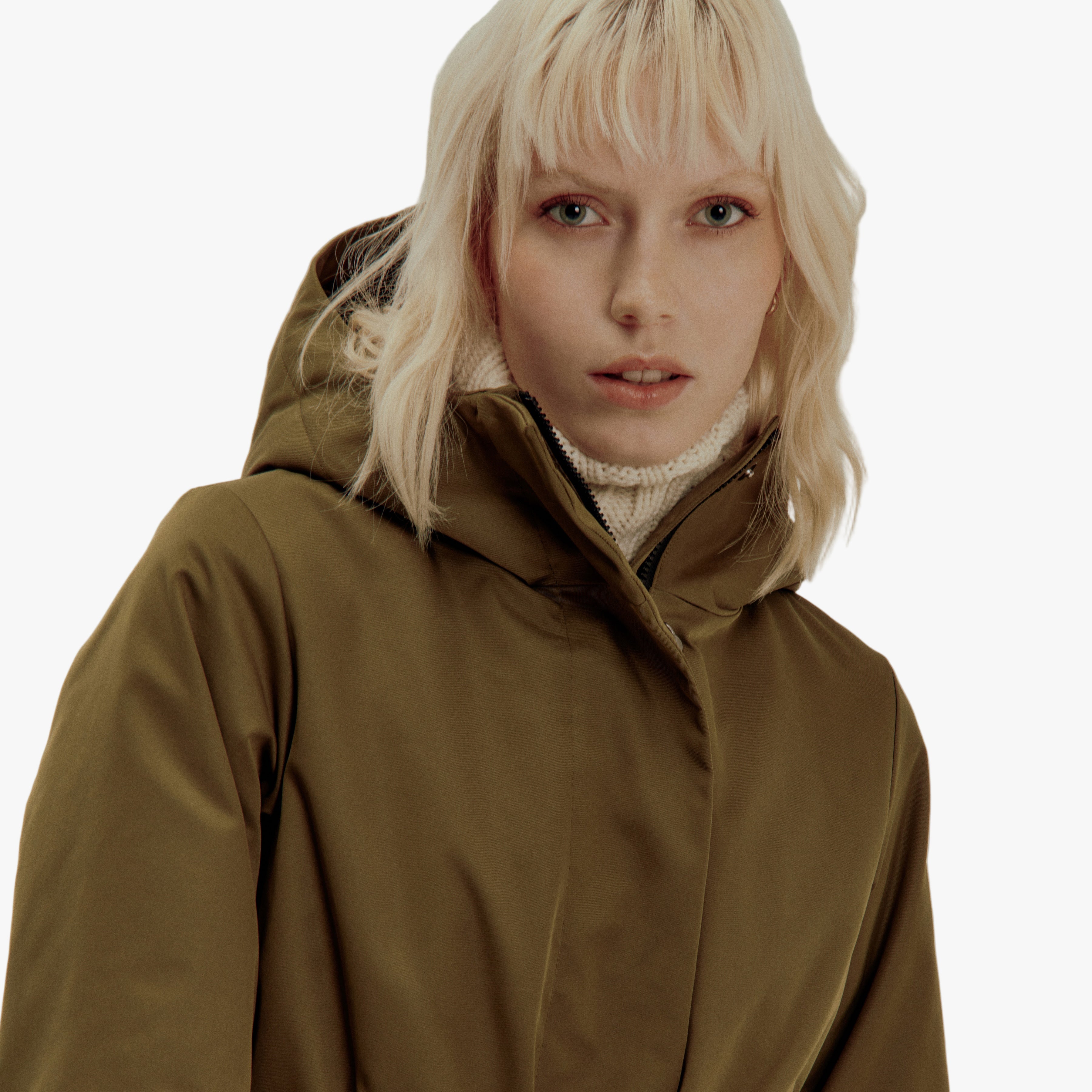 Person wearing a brown hooded jacket against a plain background