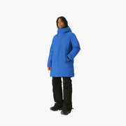 Person wearing a blue coat on a beige background