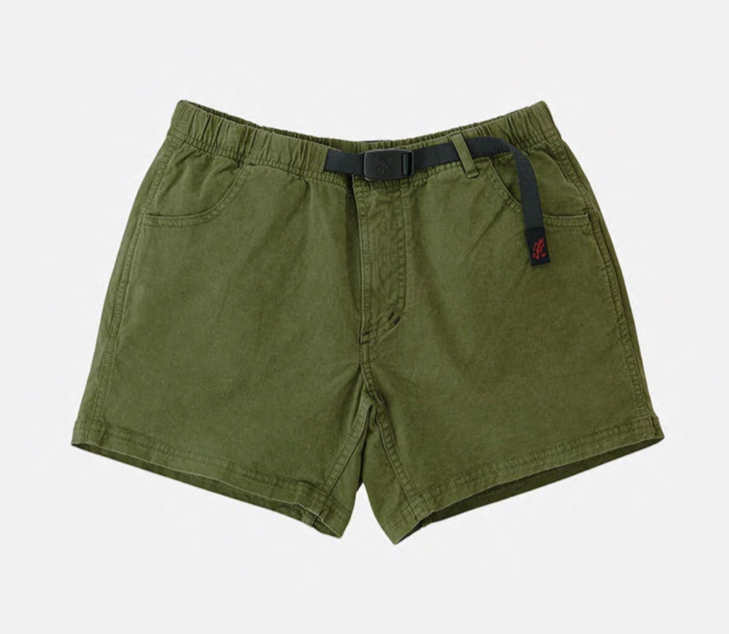 Westerlind's "Very Short, Olive" cotton stretch twill shorts feature an elastic waistband, front pockets, and a black integrated Gramicci belt—ideal for hiking. Displayed against a plain white background.