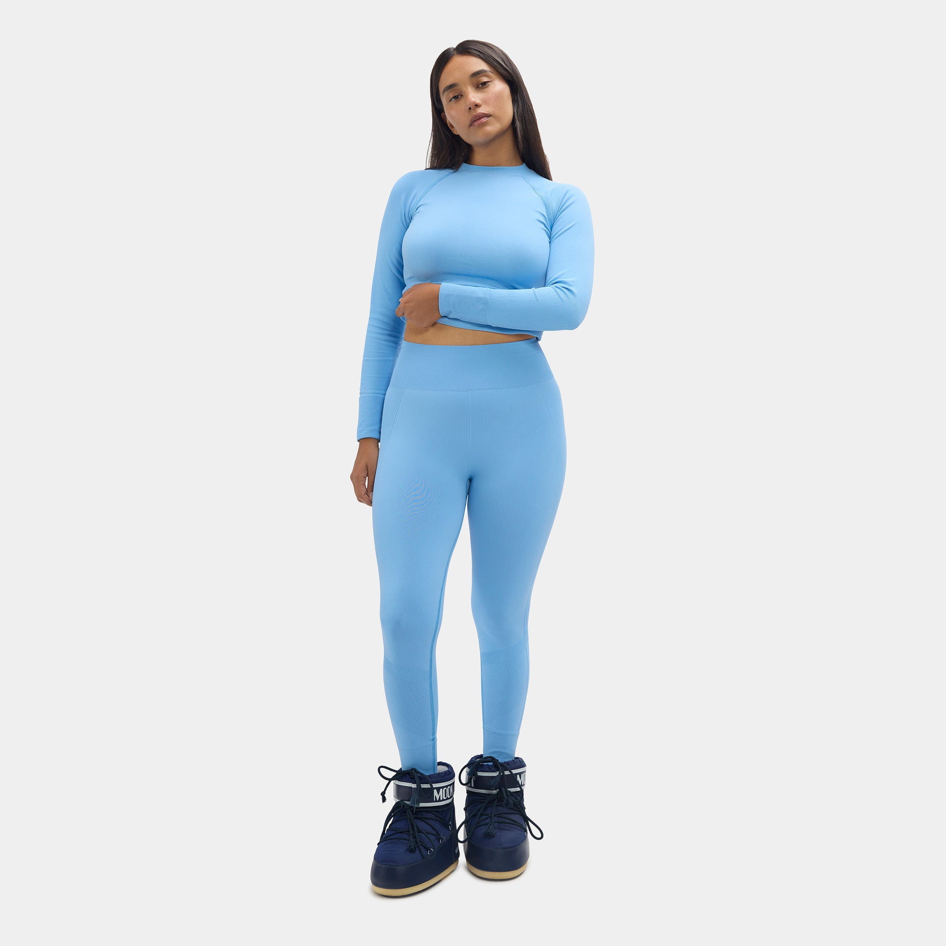 Woman wearing a blue athletic outfit on a white background