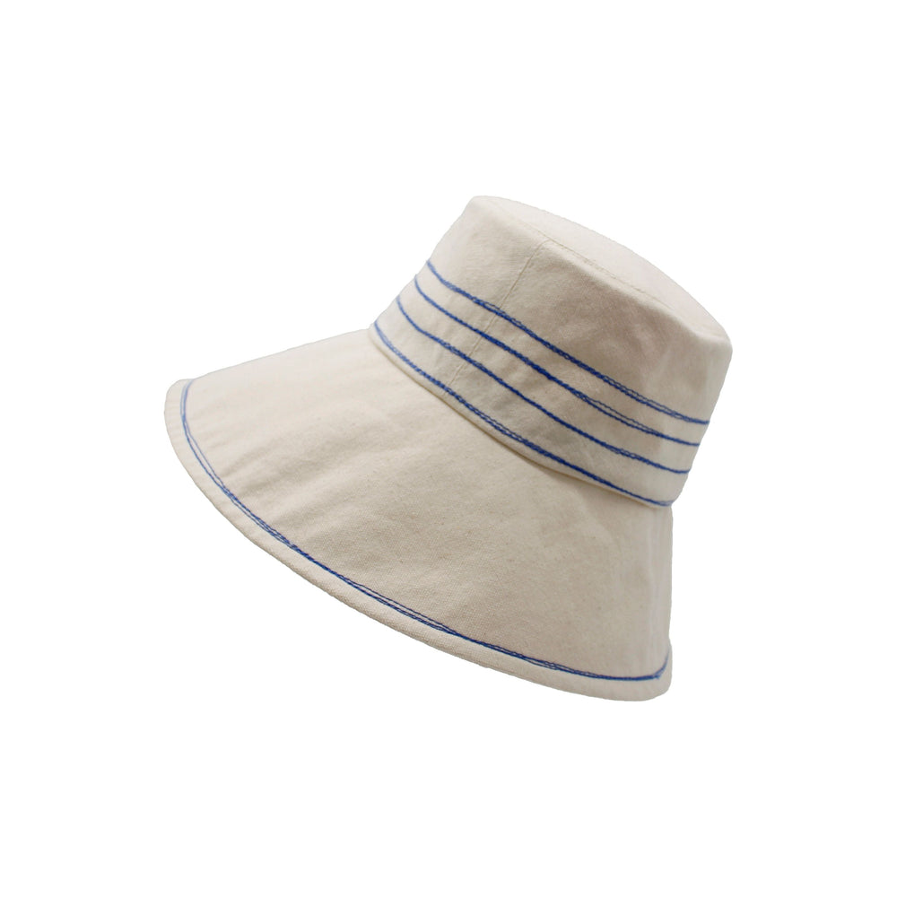 White Tide Lines bucket hat with cobalt blue stitching isolated on a white background by Lola Hats.