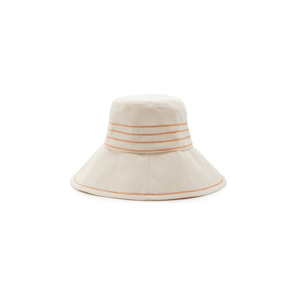 A cream-colored Lola Hats bucket hat with orange and beige Tide Lines stripes on the brim, featuring Rust stitching, isolated on a white background.