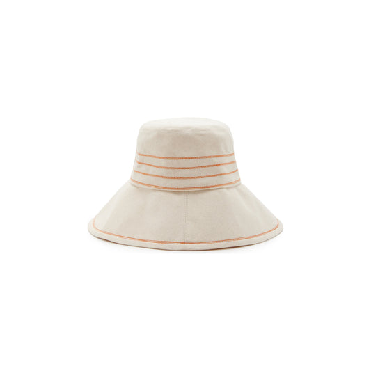 A cream-colored Lola Hats bucket hat with orange and beige Tide Lines stripes on the brim, featuring Rust stitching, isolated on a white background.