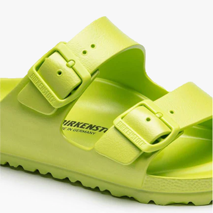 A close-up of the Birkenstock Arizona EVA Narrow sandal in Active Lime, featuring two adjustable buckle straps and a textured sole—an ideal water-friendly choice for any adventure.