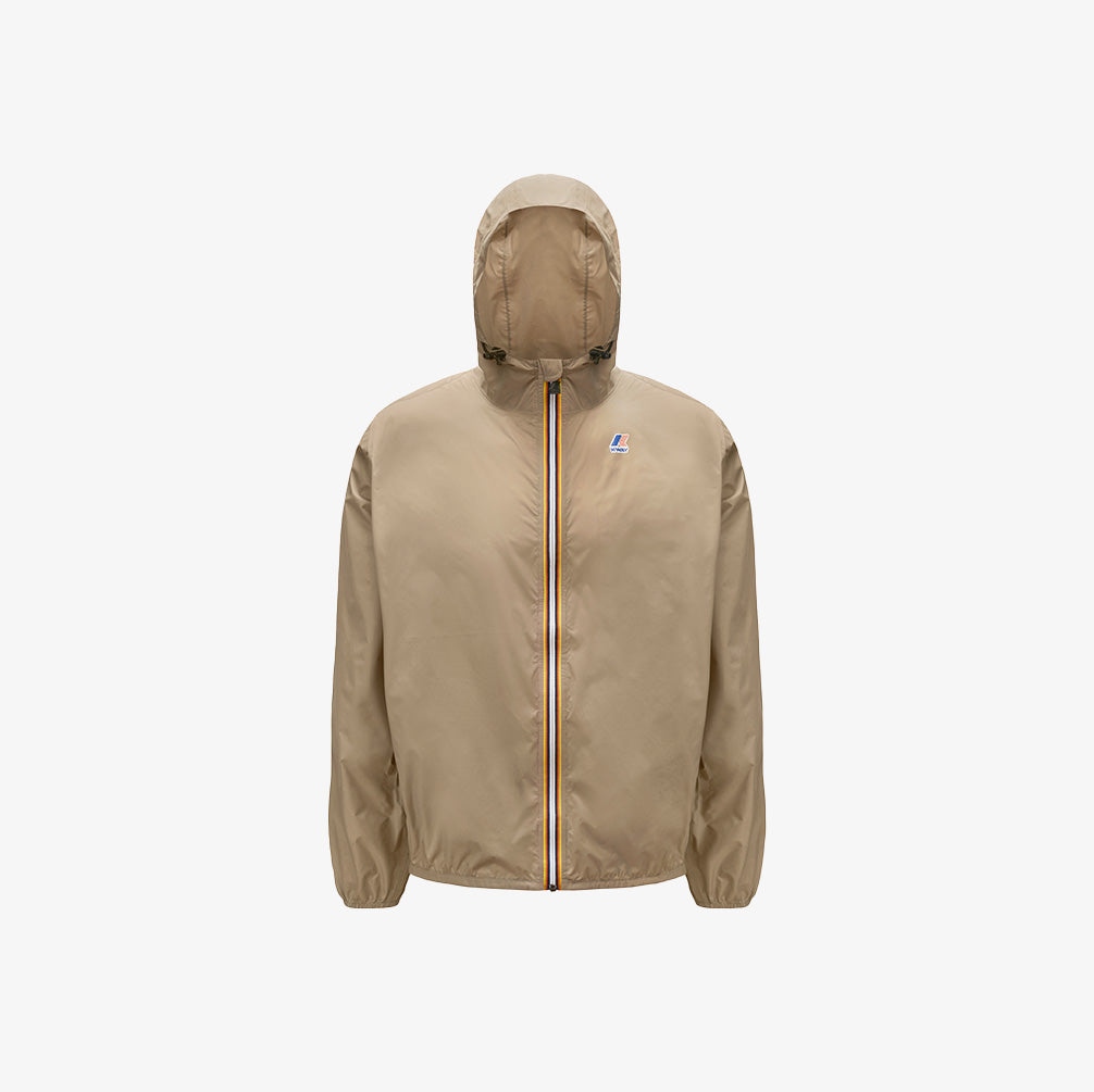 The K-Way Le Vrai 3.0 Claude in Beige Taupe is a windproof ripstop packable jacket with a front zip featuring a multicolored stripe, elastic cuffs, and a small left chest logo for comfort and durability.