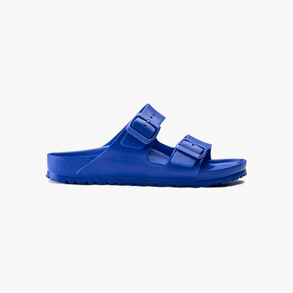 The Birkenstock Arizona EVA Regular in Ultra Blue is a unisex sandal with two adjustable buckle straps and a textured waterproof EVA sole, pictured in profile against a plain white background.
