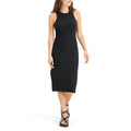 A person effortlessly walks in Dockers' black sleeveless Women's Loft Knit Tank Dress, paired with black sandals against a plain white background.