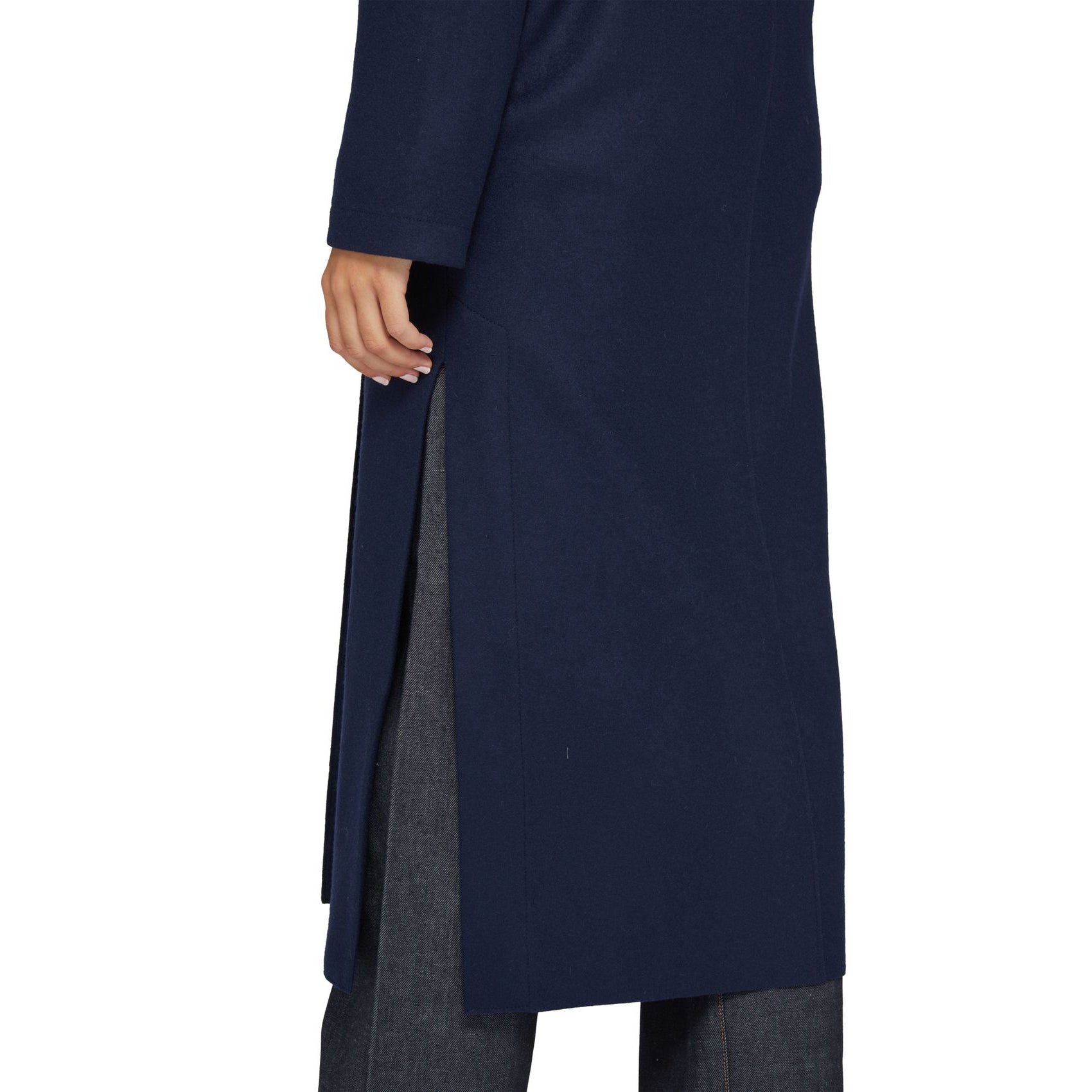 The individual wore a Harris Wharf W Long Boxy Coat Cashmere in navy, featuring a side slit, over gray pants.