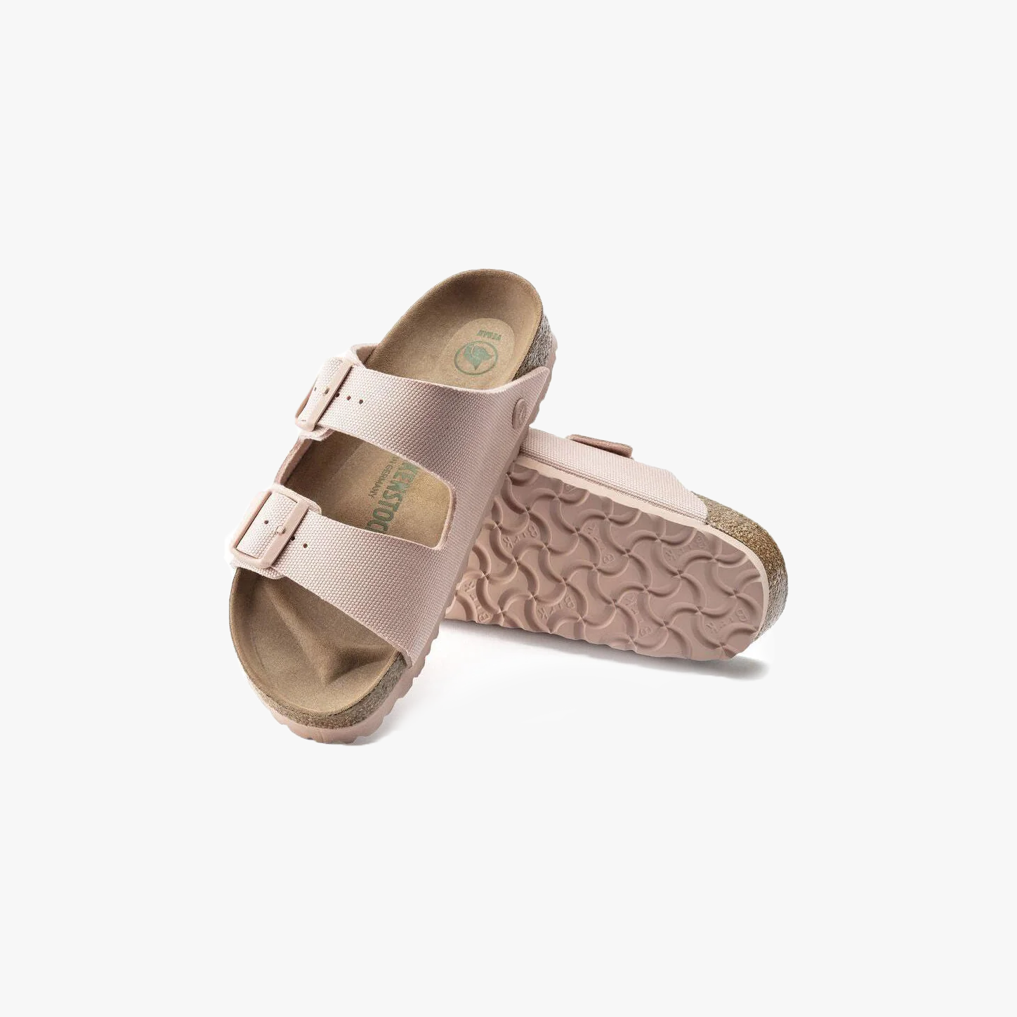 A pair of Birkenstock Arizona Vegan sandals in Canvas Soft Pink (W) with double straps and adjustable buckles—one upright, one showing the textured sole. Refer to the size chart for accurate sizing.