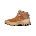 Introducing the Men's Cloudrock 2 Waterproof by On Running: a high-top athletic shoe in brown and tan featuring Cloud elements for enhanced comfort, white laces, a textured Missiongrip rubber sole, and a logo on the side.