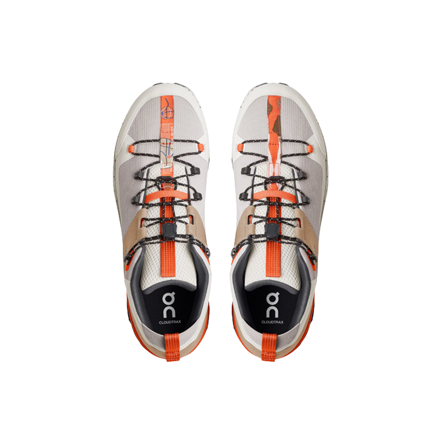 The Men’s Cloudtrax by On Running are gray and orange athletic shoes with black laces, crafted from recycled polyester, showcased from above against a black background.