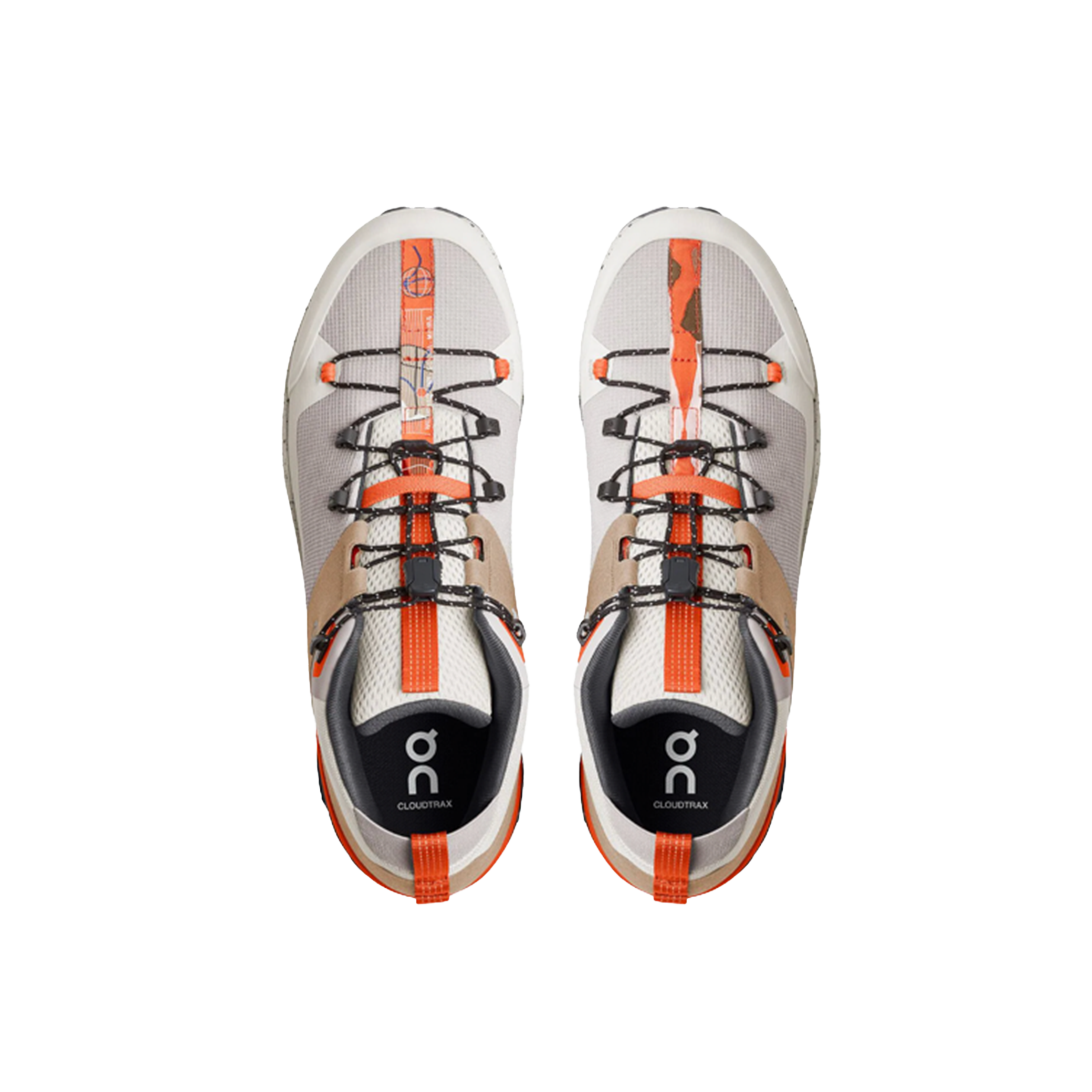 The Men’s Cloudtrax by On Running are gray and orange athletic shoes with black laces, crafted from recycled polyester, showcased from above against a black background.