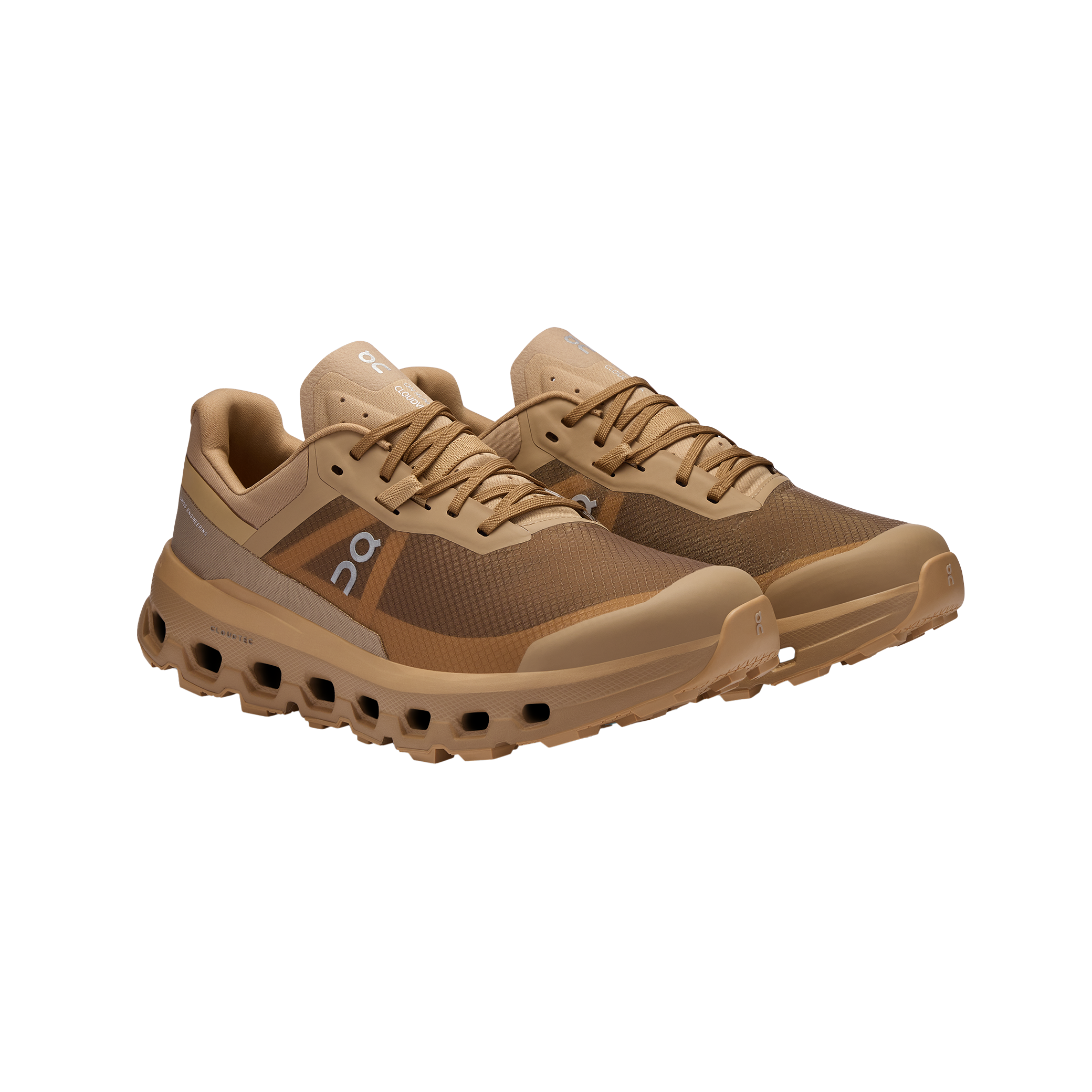 Men's Cloudvista 2 by On Running: An angled view of brown sports shoes with a mesh design, showcasing the exclusive Helion™ superfoam midsole for enhanced comfort and a cushioned sole.
