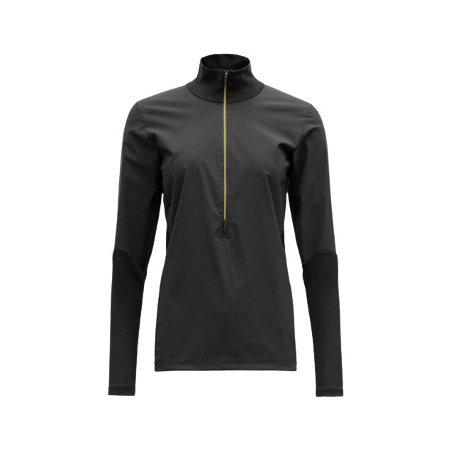 The Devold® W Running Cover Zip Neck, Caviar features a black long-sleeve design with a green zipper and high collar. Ideal as a running outer layer, it pairs perfectly with Devold® Running Cover Pants for those who value style and functionality in wind-resistant clothing against a plain white backdrop.