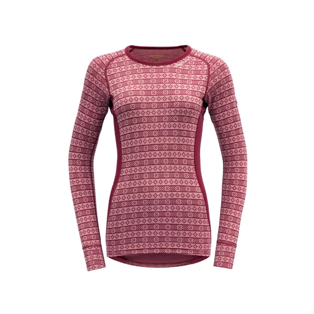 The Devold Alnes Woman Shirt in Fox Glove is a long-sleeved Merino wool top featuring a classic design with alternating rows of light pink diamond and circle shapes, ideal as an insulating baselayer.