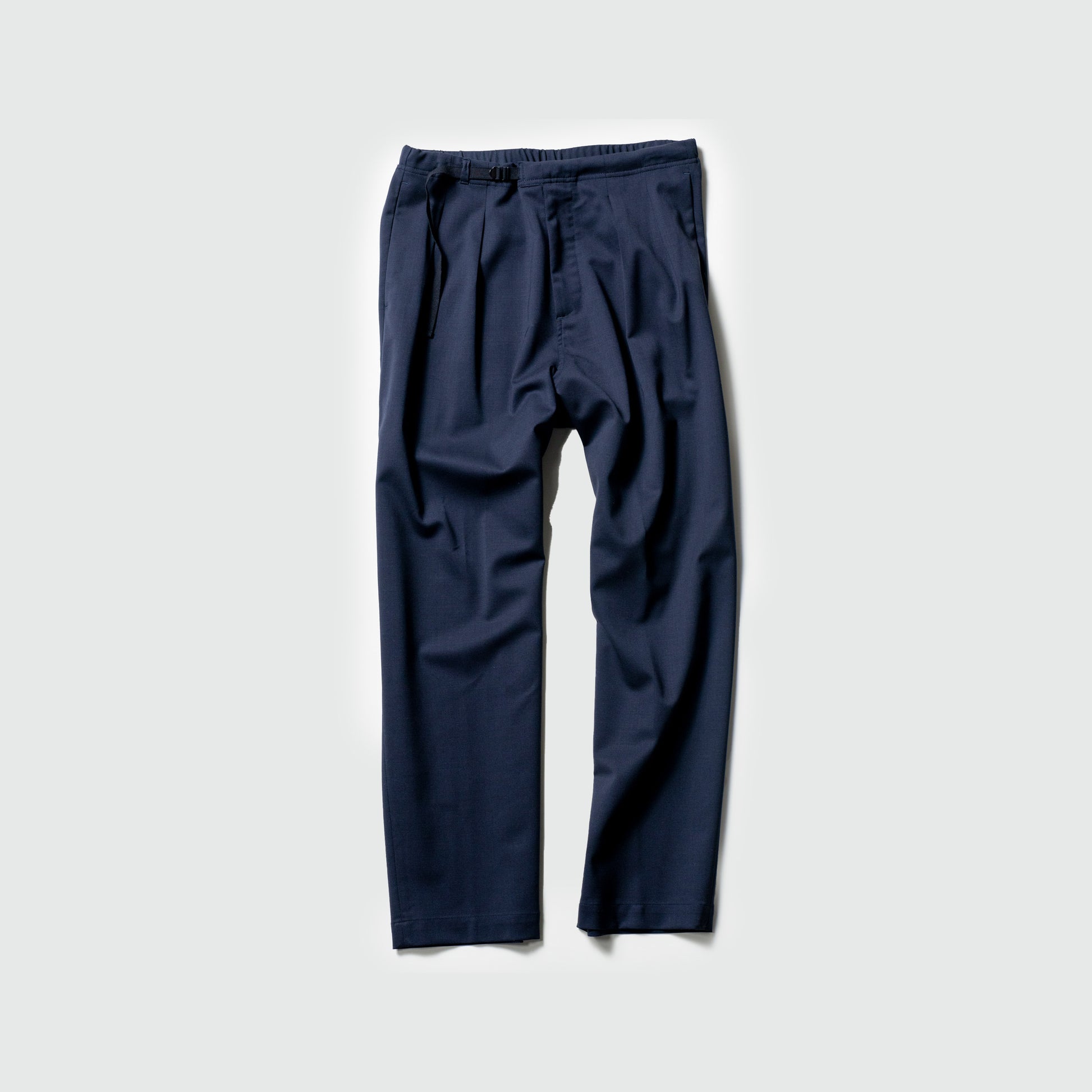 The Seven Gauge Trouser Tropical Wool in Blu features an elastic waistband with a drawstring, artfully displayed against a light gray background.
