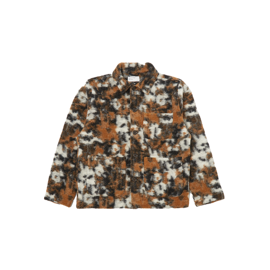 The Field Jacket Fleece by Universal Works offers a loose fit and is crafted from a wool polyester blend, showcasing a brown, black, and white abstract pattern with multiple pockets on display against a plain background. It is expertly designed for men's sizing.