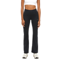 A person stands facing forward wearing Rohnisch's Flattering High Waist Pants. Their outfit, featuring a white crop top and white sneakers, is accentuated by the plain background. The breathable fabric of the leggings ensures comfort while highlighting a stylish look.