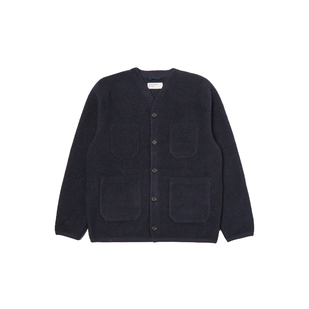 Navy blue Fleece Cardigan by Universal Works in a wool blend, featuring four patch pockets and button-up design, displayed on a white background.
