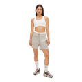 A person in a white crop top, light gray Frankie Wind Shorts by Rohnisch, high white socks, and sneakers with the Rohnisch logo stands against a plain background.