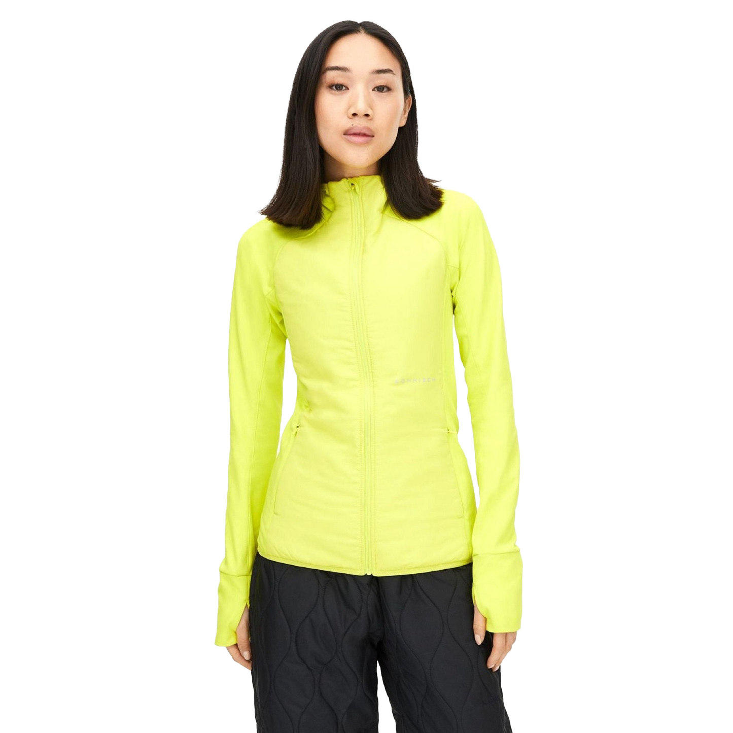 A person wearing the Rohnisch Free Motion Padded Jacket in bright yellow and black pants stands against a plain background.