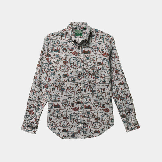 The Ski Club Print, Grey Pattern shirt by Gitman Vintage is a long-sleeve, button-up with a lively print of badges, shapes, and outdoor graphics on a light background.