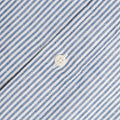 Close-up of the Blue Stripe Linen Shirt by Gitman Vintage, featuring blue and white striped fabric with a white button at the center.