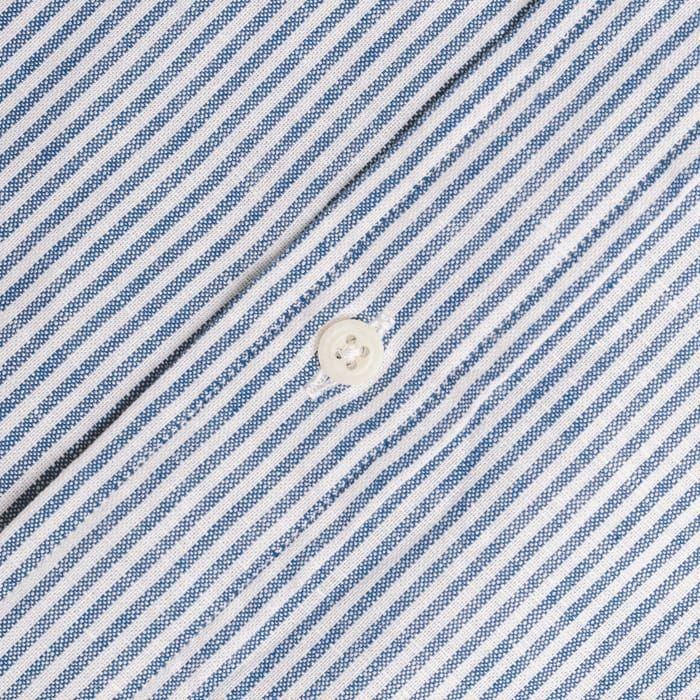 Close-up of the Blue Stripe Linen Shirt by Gitman Vintage, featuring blue and white striped fabric with a white button at the center.