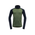 The Devold M Expedition Arctic Hoodie in Forest Ink is a green and dark blue Merino wool long-sleeve pullover. It features a hood, thumbholes, kangaroo pocket, and high collar for comfort and is part of the Expedition series.