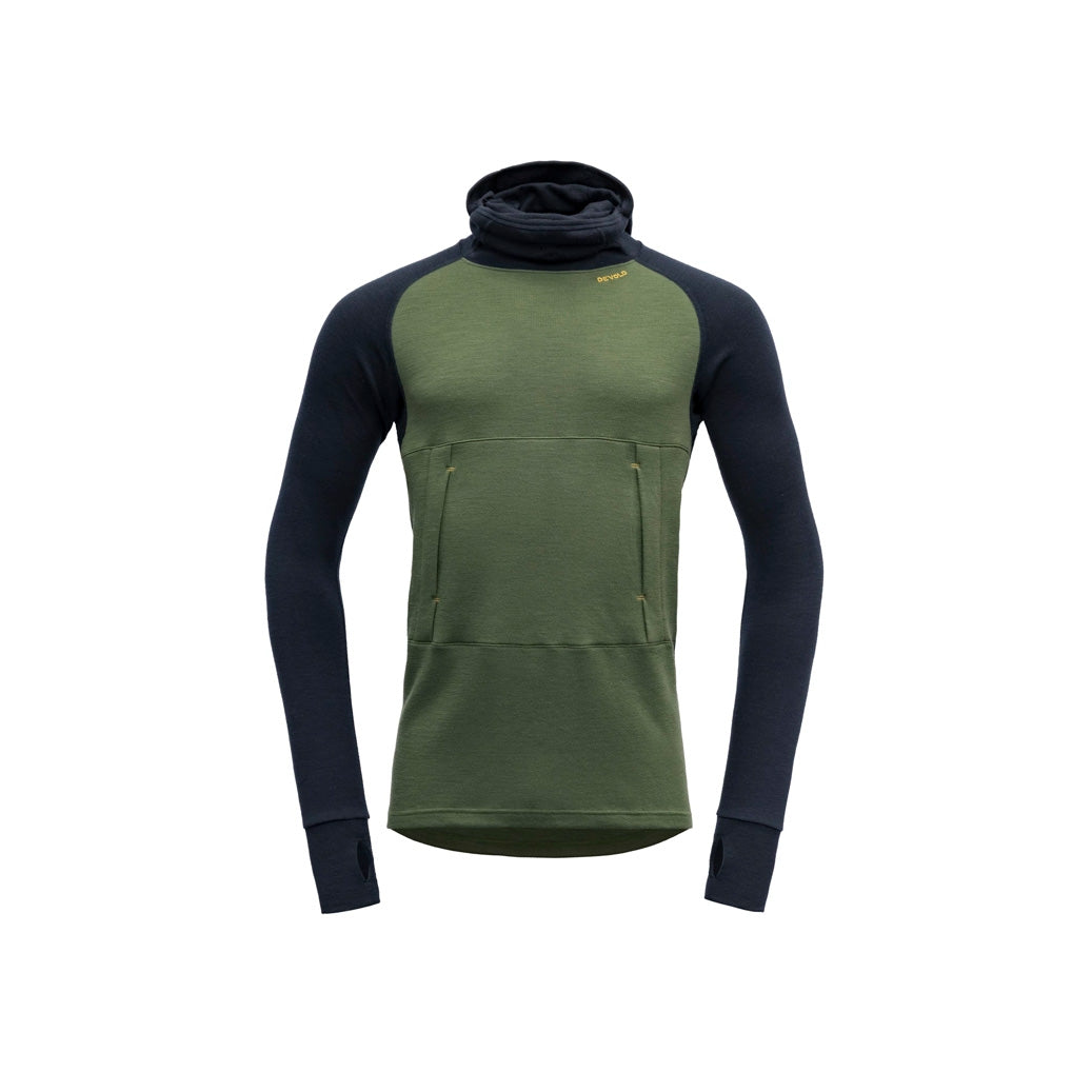 The Devold M Expedition Arctic Hoodie in Forest Ink is a green and dark blue Merino wool long-sleeve pullover. It features a hood, thumbholes, kangaroo pocket, and high collar for comfort and is part of the Expedition series.