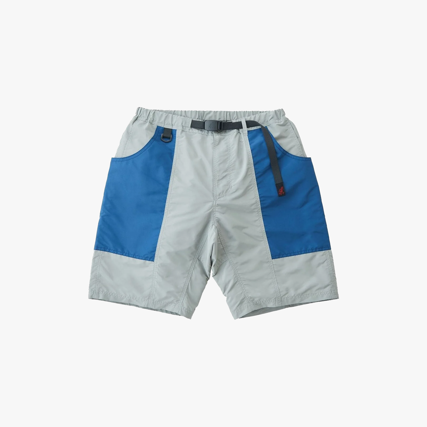 The Gramicci Shell Gear Short in Grey/Navy features blue side panels, large front pockets, an elastic waistband, and an integrated belt—perfect for hiking or outdoor adventures.