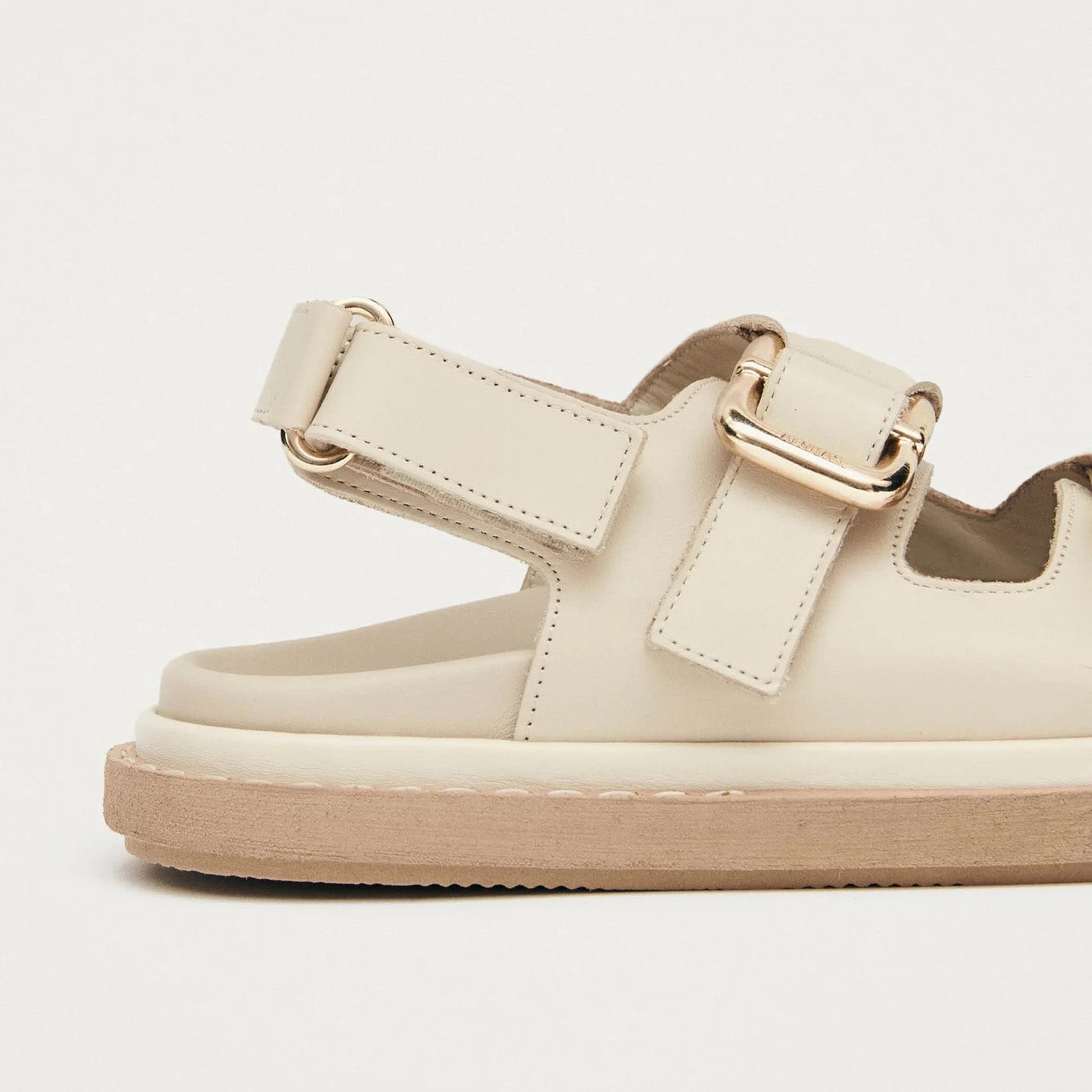 The Harper Sandal by Alohas in cream features a chunky sole, open toe, and adjustable buckle straps with metal buckle detail.