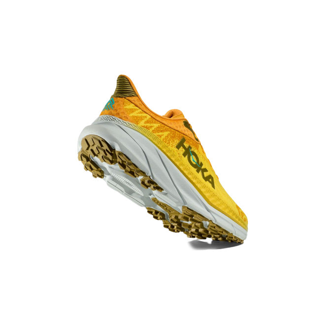 The M Challenger ATR 7 in Passionfruit/Golden Yellow by Hoka features a rugged outsole and white midsole for an all-terrain experience. Its heel tread pattern enhances traction on all surfaces.