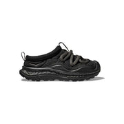 The U Ora Primo by Hoka boasts a black sneaker design with a textured sole, thick gray laces, a low collar, and an insulated puff upper. Perfect for recovery days, it offers easy slip-on functionality for added comfort.