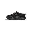 The sleek side view of the Hoka U Ora Primo in black showcases its slip-on comfort, featuring thick laces and a textured sole, set against a plain white background.