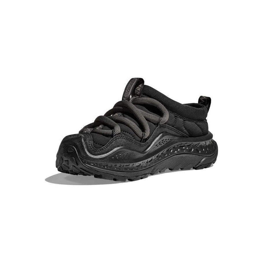 The Hoka U Ora Primo in black features a thick slip-on comfort sole and chunky laces, set against a plain white background.